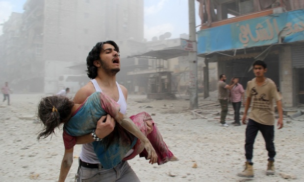 man trying to rescue child_syria