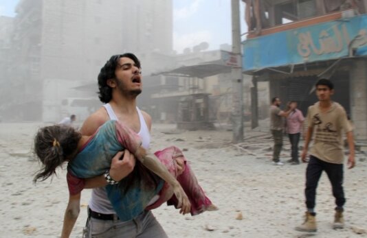 man trying to rescue child_syria