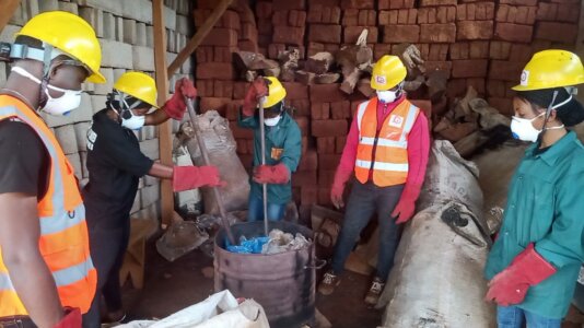 Pierre Sunday supervises the his collaborators as they melt plastic waste for blocks (Photo credit-Pierre Sunday)